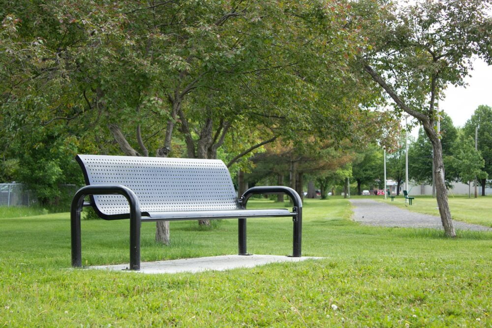 Bench with steel backrest installed in the public park - Décors Véronneau