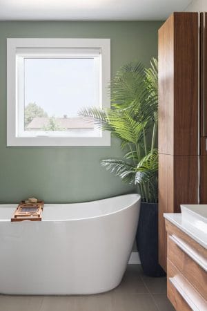 Artificial indoor palm in a bathroom, in a large pot