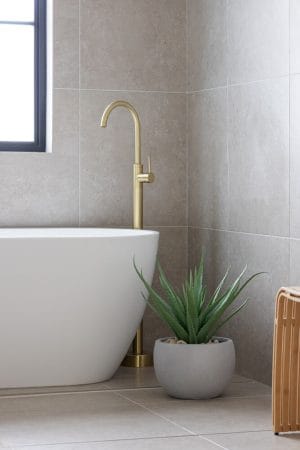Artificial aloe plant in a concrete pot in a bathroom
