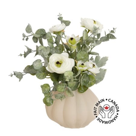 Small arrangement of white flowers and eucalyptus in a vase