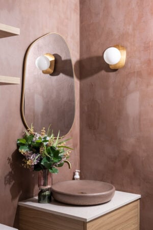Windowless bathroom with a small bouquet of artificial flowers