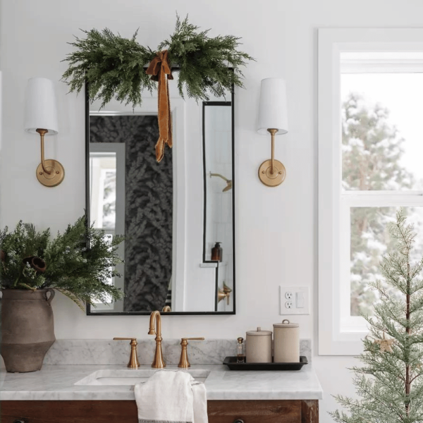 Salle de bain avec miroir décoré d'une guirlande de cèdre
